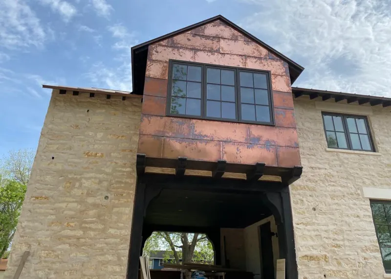 Copper metal panel facade on a stone building for Skylight Installation in Purcellville