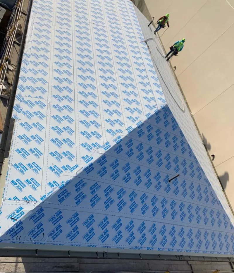 Professional roofers installing underlayment on a metal roof in Purcellville